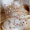 Clear sticker sheet featuring gold and iridescent 3D ocean-themed nail art stickers like starfish and shells