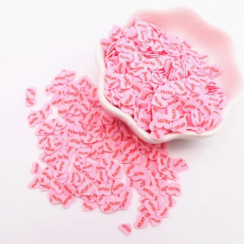 A pink bowl filled with small pink polymer clay sprinkles for slime decor and DIY craft accents