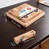 A wooden jigsaw puzzle set featuring a white van with a red cross on a light wood background.