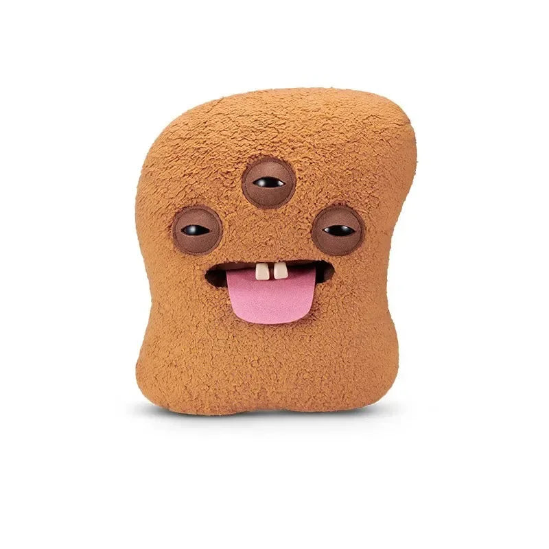 A brown, fuzzy plush toy shaped like an ugly fried chicken nugget monster with large eyes and a pink tongue.