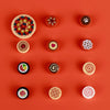 A collection of mini food building blocks including pizza, cake, and condiment shaped bricks on an orange background.