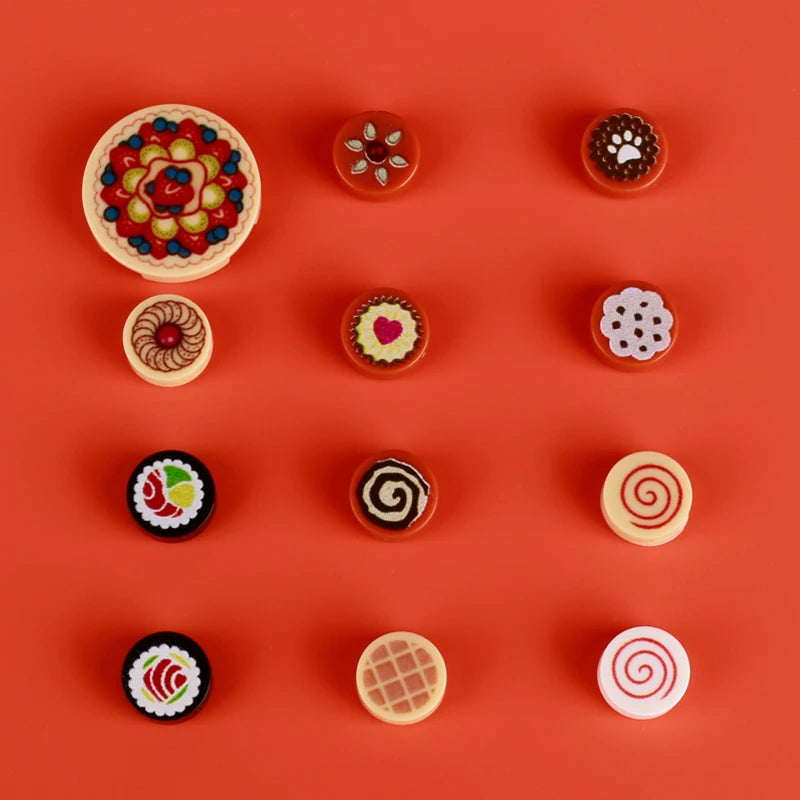 A collection of mini food building blocks including pizza, cake, and condiment shaped bricks on an orange background.