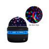 A black projector night light featuring a star and moon pattern projection.