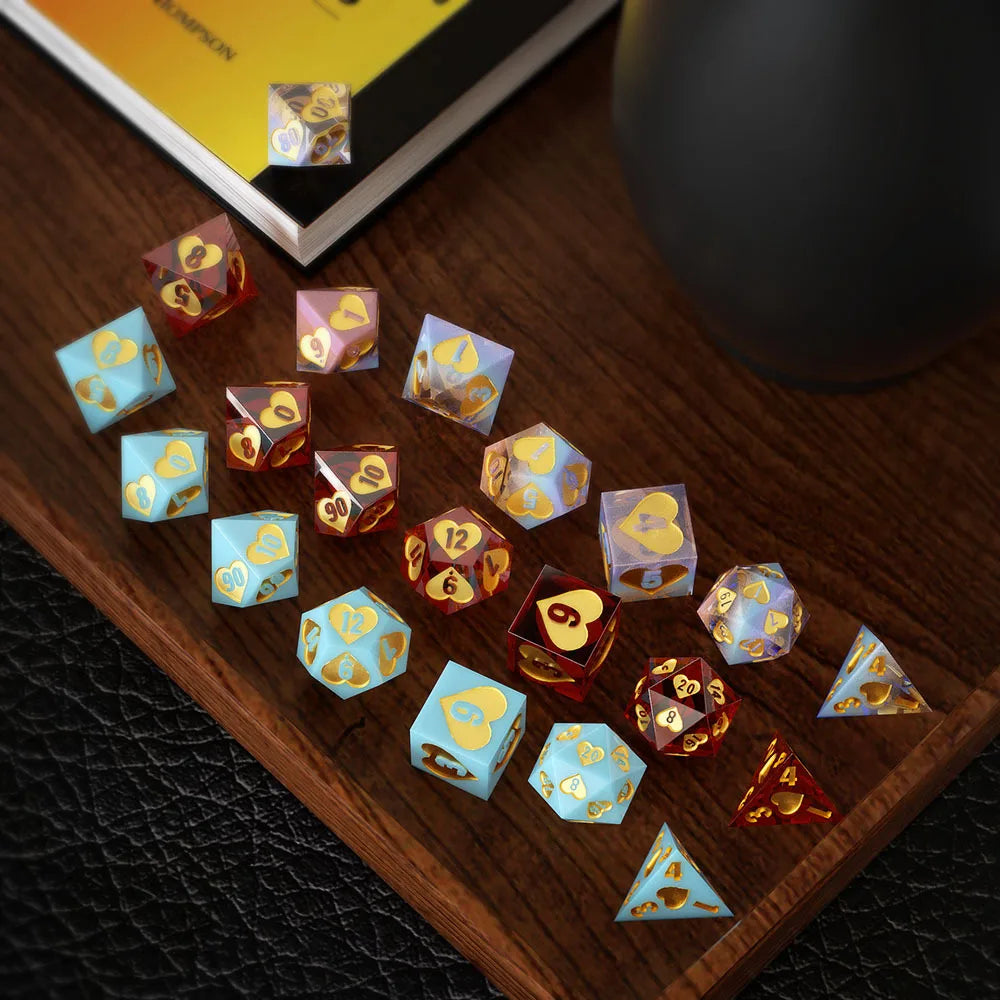 A collection of small, colorful hexagon silicone resin molds shaped like dice, arranged on a wooden surface.