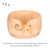 Handcrafted wooden yarn bowl with a swirl cutout, made by joining wooden blocks.