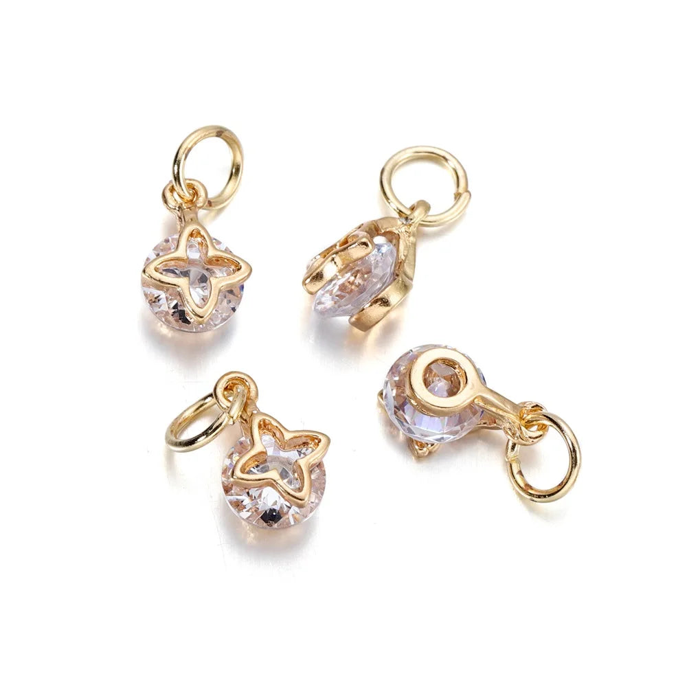 Gold and silver rhinestone heart charms for jewelry making displayed on a white background