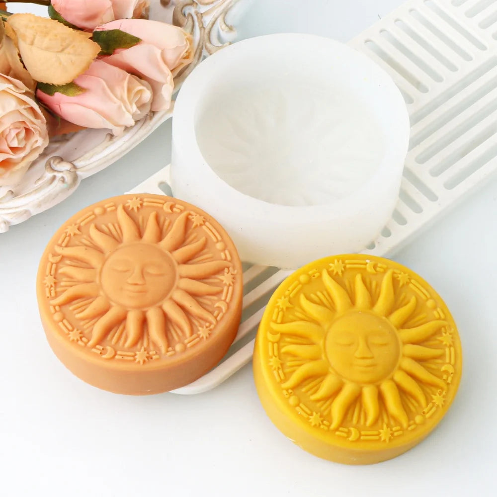 Two round silicone molds shaped like suns in orange and yellow colors are displayed next to a white silicone bowl.