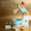 A light blue blender toy is shown with a wooden bowl and food items on a table.