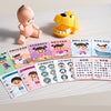 A set of colorful plastic toys featuring a baby figure and a dog, along with various cards for learning medical concepts.