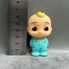 A light blue cartoon figurine of a child wearing a matching blue shirt with yellow dots, next to a ruler.