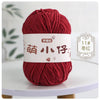A ball of deep red chenille yarn labeled with Chinese characters for knitting and crochet.