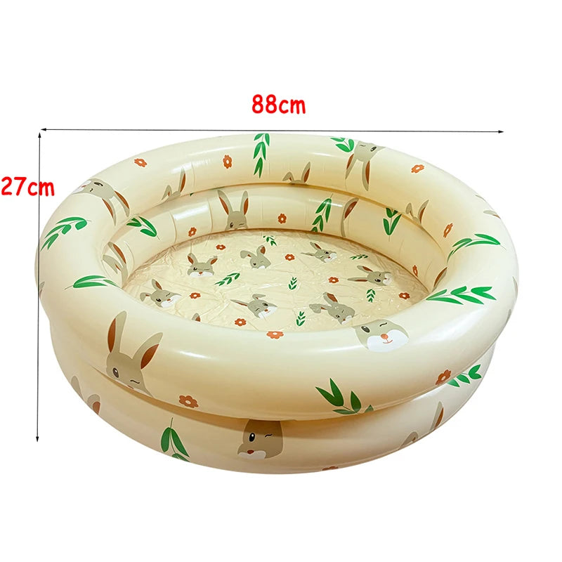 A round inflatable toddler pool with a light beige color and a pattern of woodland animals and leaves.