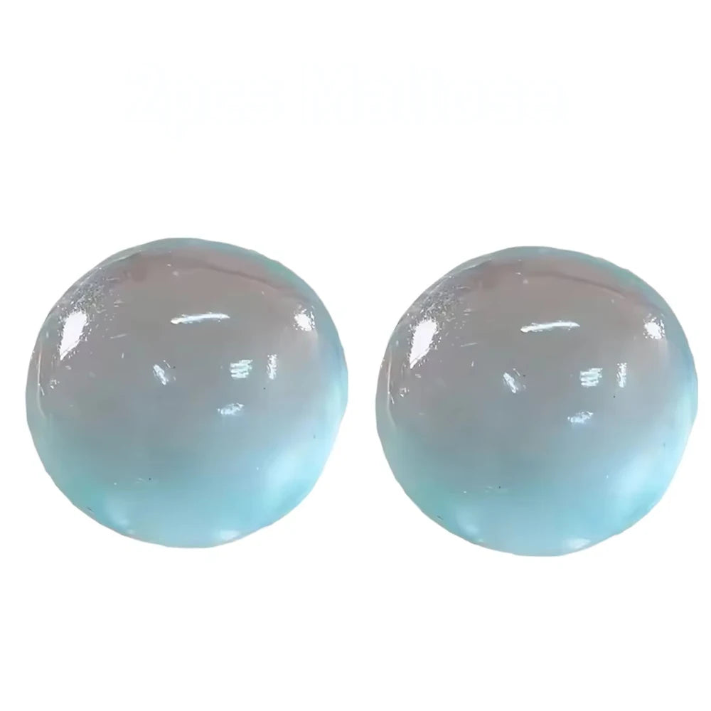 A pair of translucent light blue squishy stress relief toys.