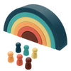 A rainbow arch made of soft silicone building blocks in pastel colors, including blue, green, yellow, orange, and pink.