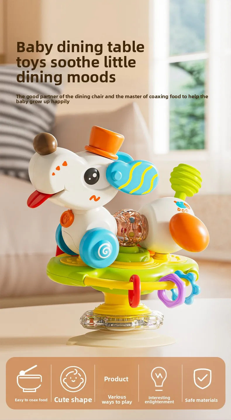A white cartoon baby rattle toy with various colored parts and a suction cup base sitting on a table.