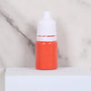 An orange bottle of water marbling paint art kit for kids with a white cap sitting on a white surface.