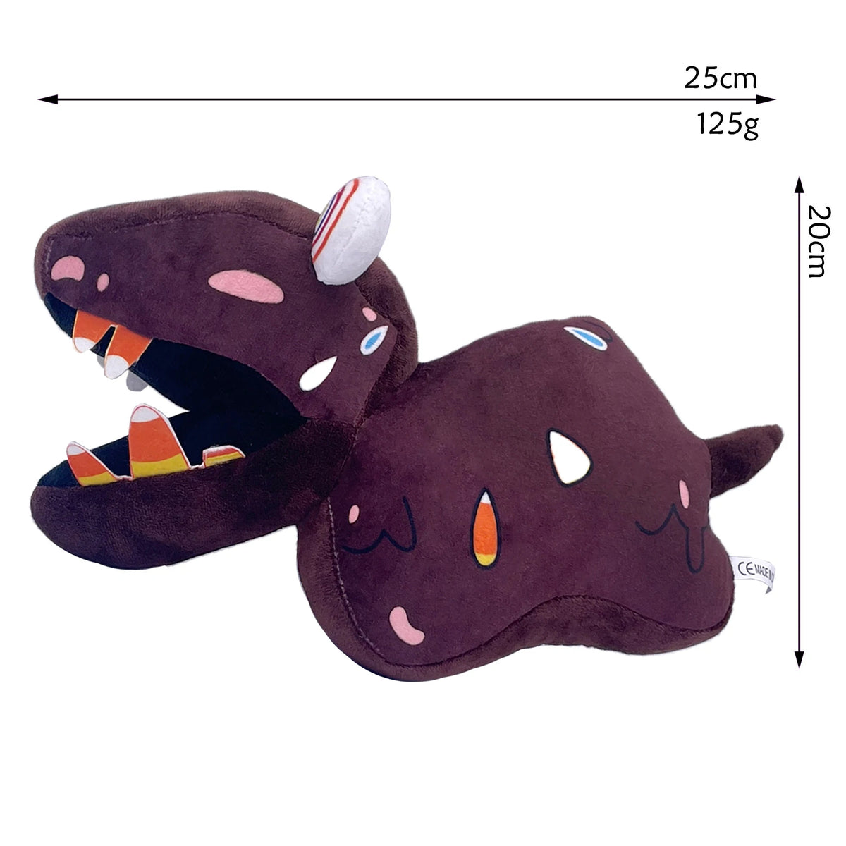 A dark purple plush toy resembling a monster with an open mouth showing teeth and a white ear