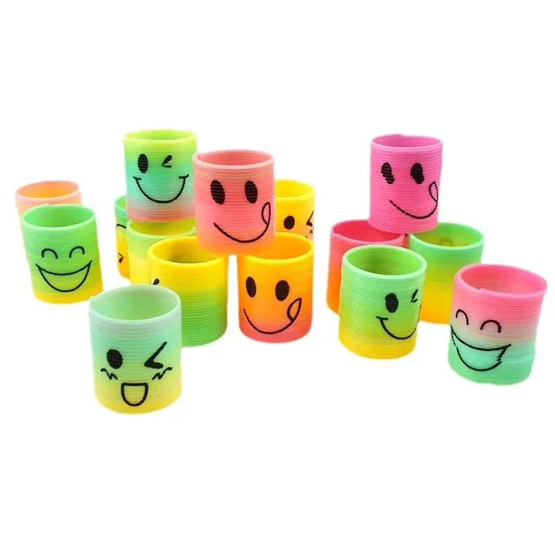 A set of twelve colorful rubber bands shaped like smiling faces in various colors stacked together
