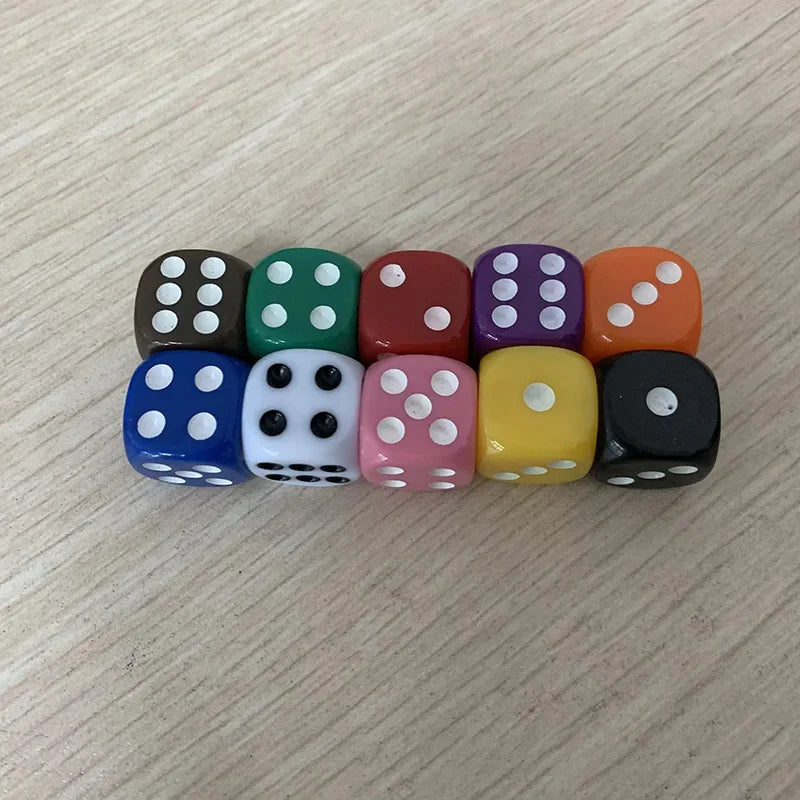 A row of ten colorful solid acrylic dice in various colors including black, green, red, purple, orange, and yellow.