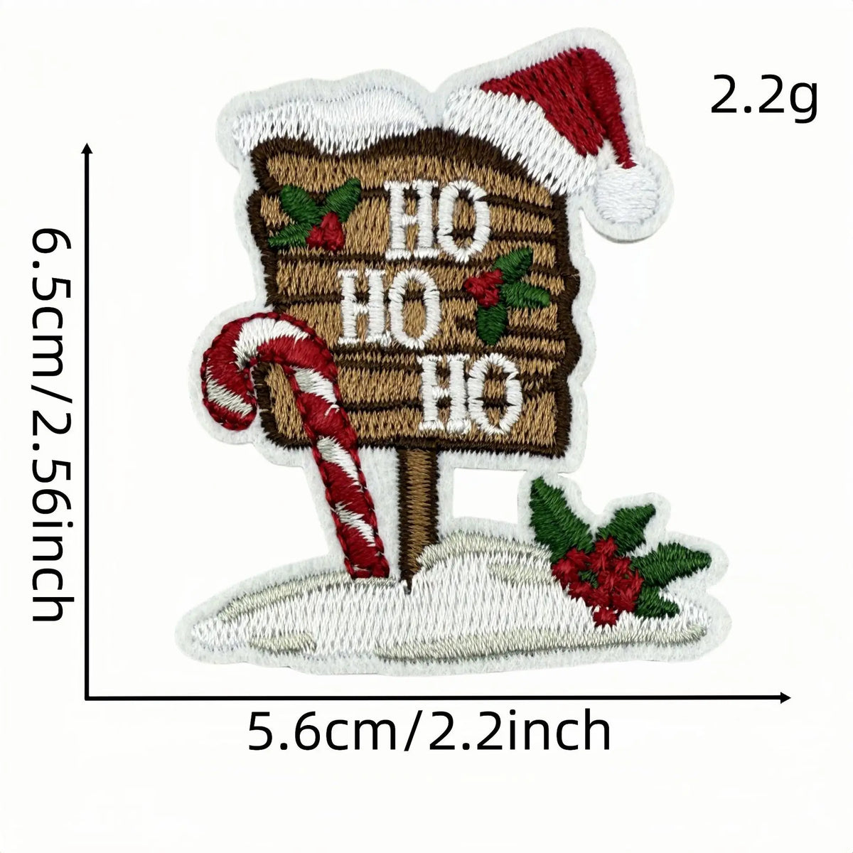 A festive cartoon character iron-on patch depicting a Santa hat, a wooden sign with 'HO HO' text and holly, and a candy cane.