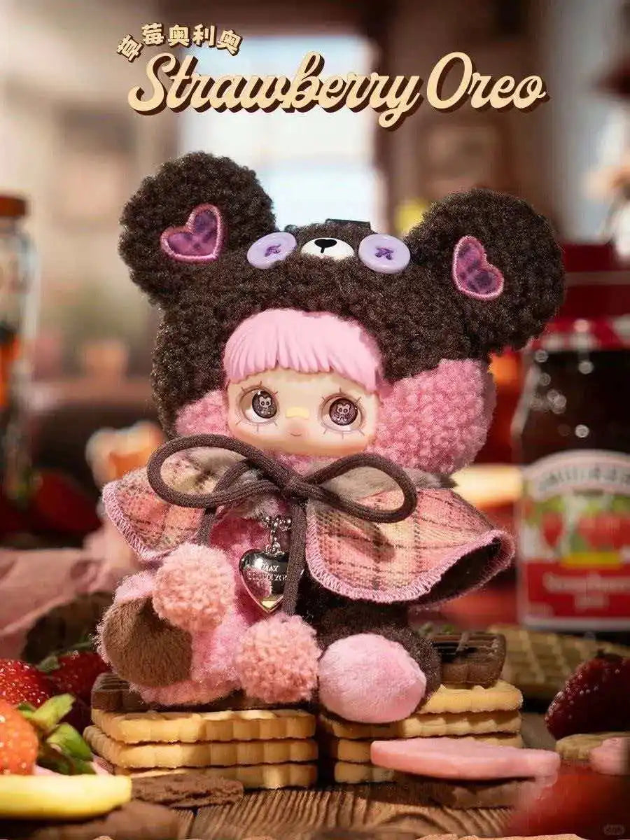 A fluffy strawberry Oreo themed blind box plush charm featuring a bear face and pink accents.