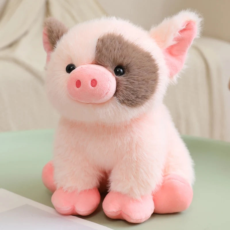 A pink and gray plush pig stuffed animal with large ears and a pink snout.