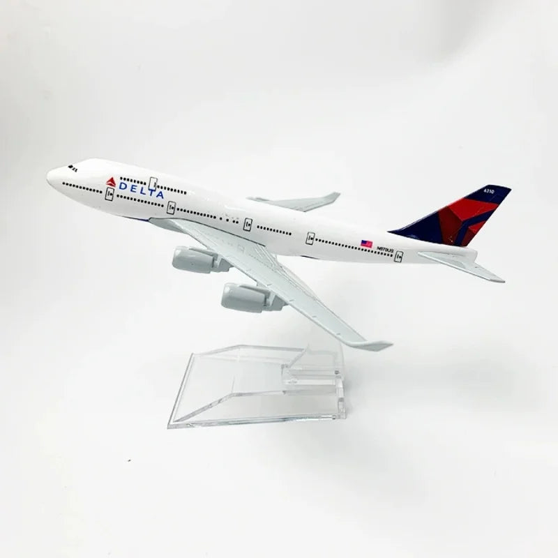 A diecast model airplane of a Delta Airlines Boeing 747 in white and blue livery.