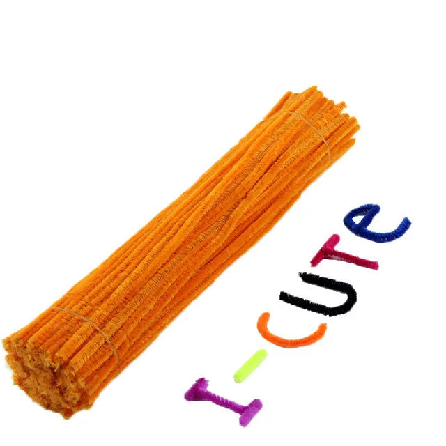 A bundle of orange pipe cleaners spelling the word 'ICUTE' is shown.