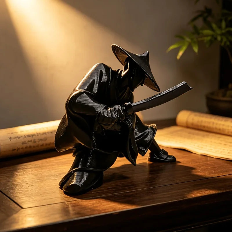 A dark bronze 3D printed samurai warrior figurine with a wide-brimmed hat and sword, displayed on a wooden surface.