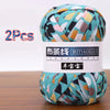 A ball of soft chunky t-shirt yarn in various teal, pink, and green patterns is shown.