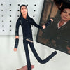 A dark-clad doll resembling Michael Jackson stands in a full-body pose against a white background.
