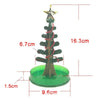 A small, dark green crystal growing tree decoration with a gold star topper and a green base.