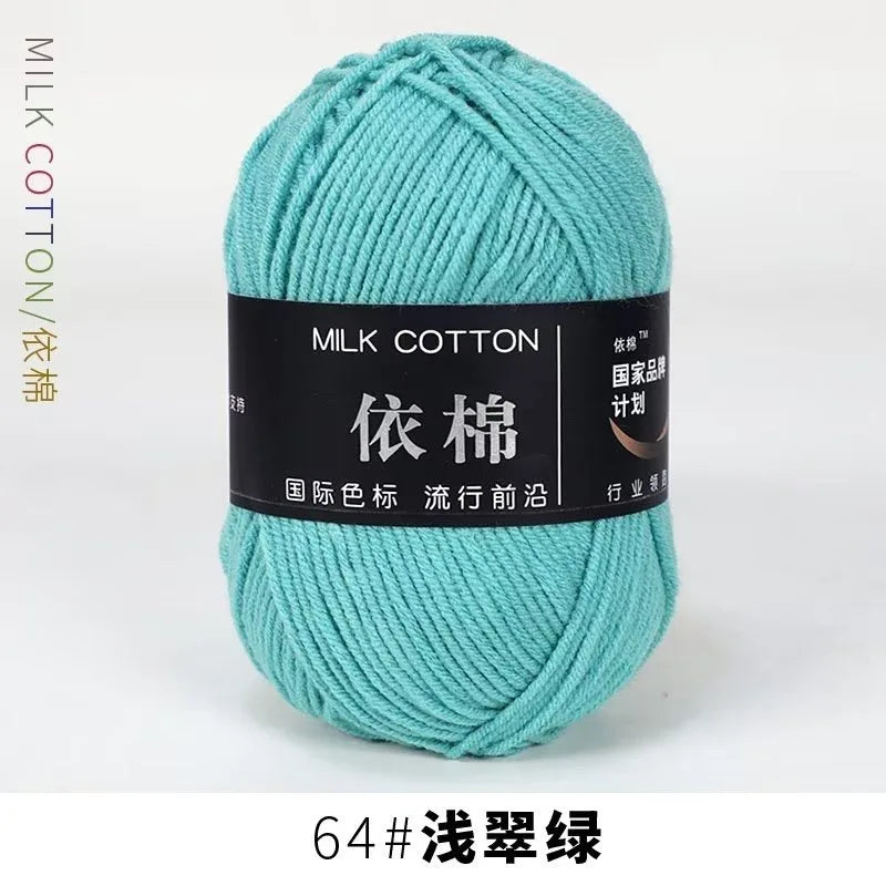 A ball of teal milk cotton yarn labeled as 64# washed thread for knitting and crochet.