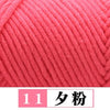 A close-up of bright pink premium milk cotton yarn with a diagonal knit pattern.