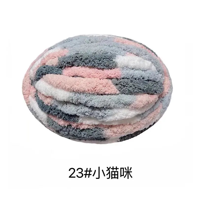 A round ball of soft, fluffy chenille yarn in a mottled pattern of gray, pink, and white.
