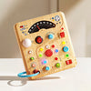 A wooden interactive circuit busy board featuring various lights, switches, and dials for educational play.