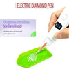 A hand holds an electric diamond pen, demonstrating vacuum suction technology for picking up and placing diamonds onto a gree