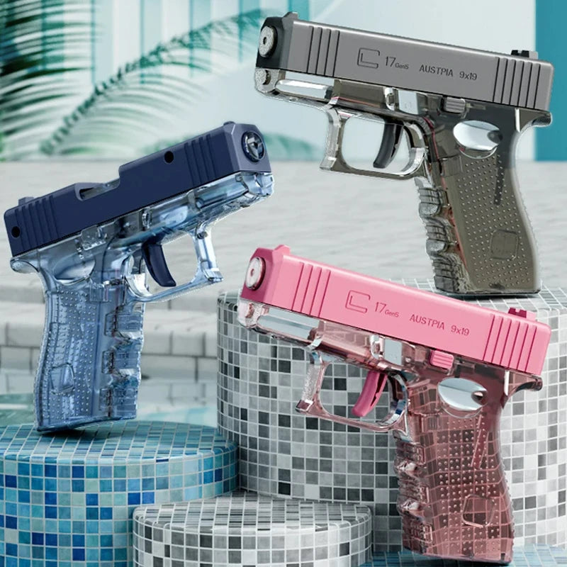 A collection of three high-power water blaster guns in blue, silver, and pink resting on a tiled surface.