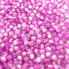 Close-up of small, round, pink glass crackle beads for jewelry making.