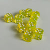 A collection of bright yellow transparent dice arranged in a loose cluster on a white surface.