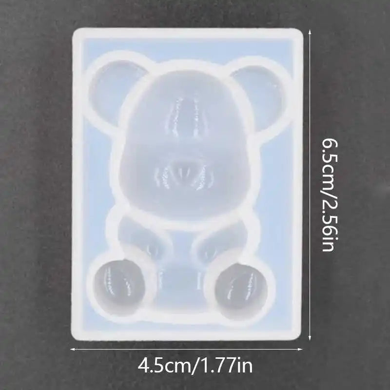 A clear silicone mold shaped like a bear for resin jewelry and crafts.