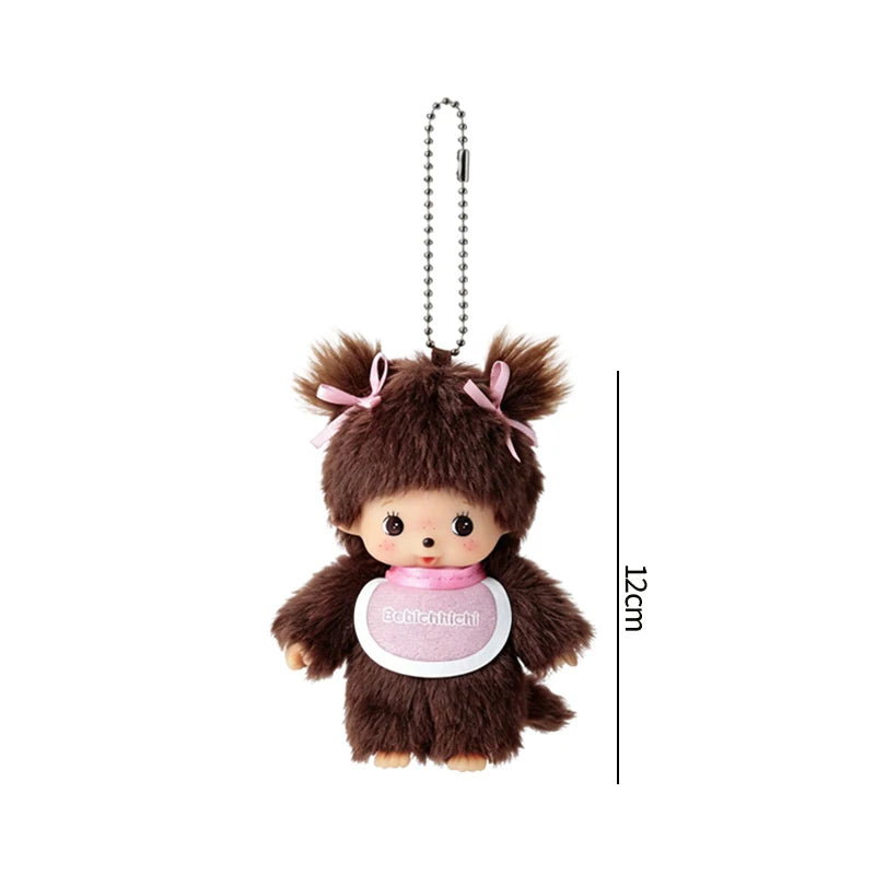 A brown fluffy plush cartoon charm with pink accents hanging from a silver chain.