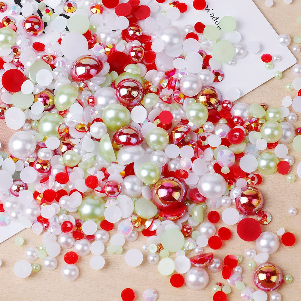 A scatter of mixed resin rhinestone pearls in various colors including red, pink, green, and white on a wooden surface.