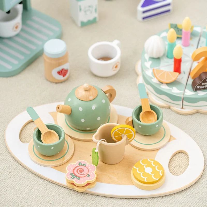A wooden pretend play tea party set featuring a teapot, cups, and serving plates for children.