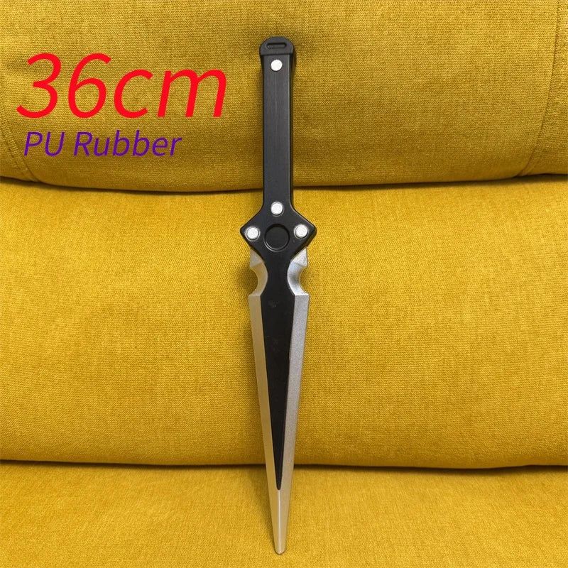 A black sawtooth dagger knife prop is displayed against a yellow fabric background.
