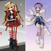 A pair of anime-style BJD dolls, one blonde and one purple, dressed in detailed street style outfits.