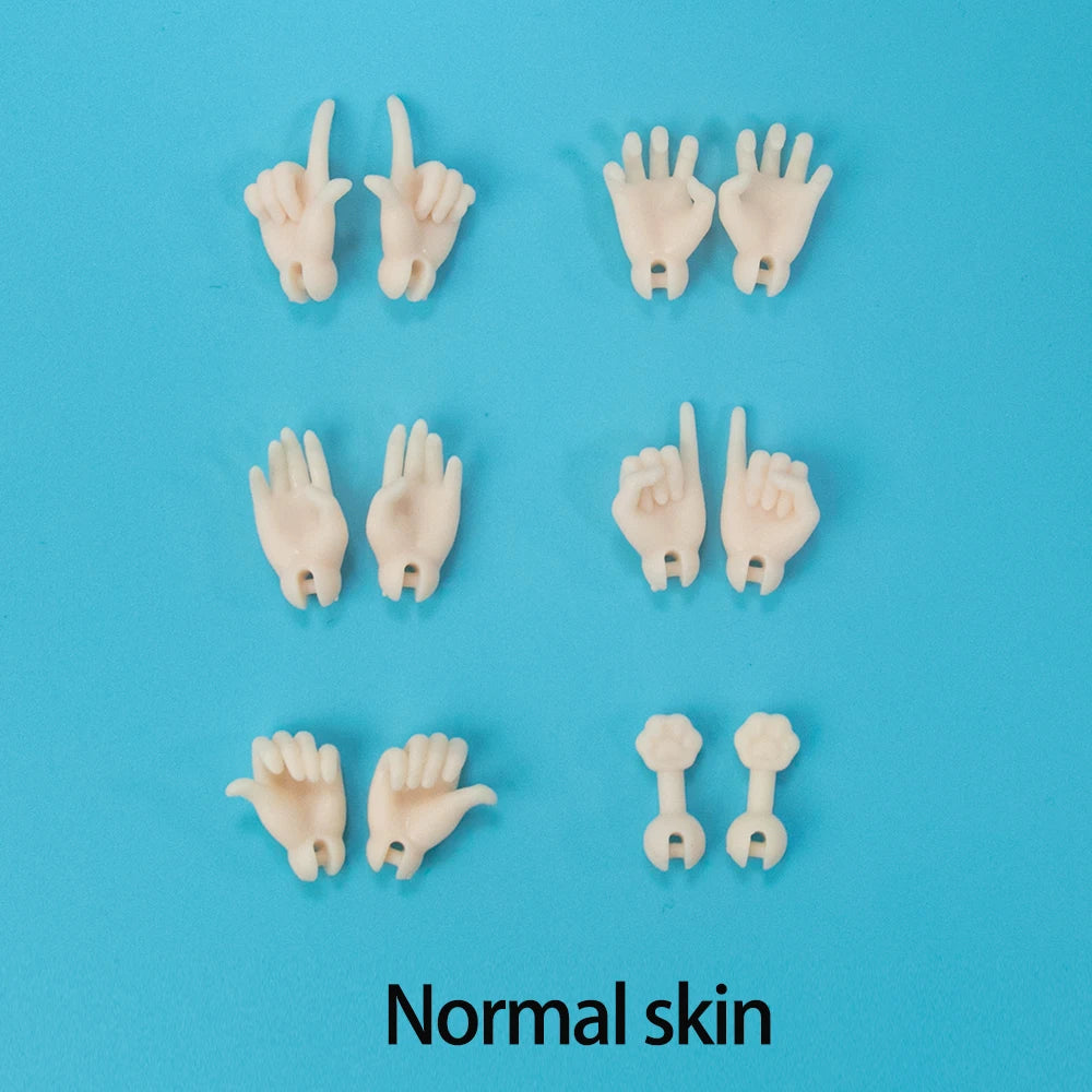 A collection of pale pink silicone hands demonstrating various gestures and forms of normal skin texture.