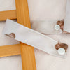 A set of three waterproof wet and dry bags for swimsuits, diapers, and travel, featuring light beige fabric and wooden accent
