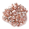 A pile of rose gold and silver-toned acrylic bow and flower beads for DIY jewelry making