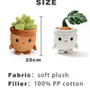 A soft plush toy of a succulent plant in a terracotta pot with green leaves and a small face.